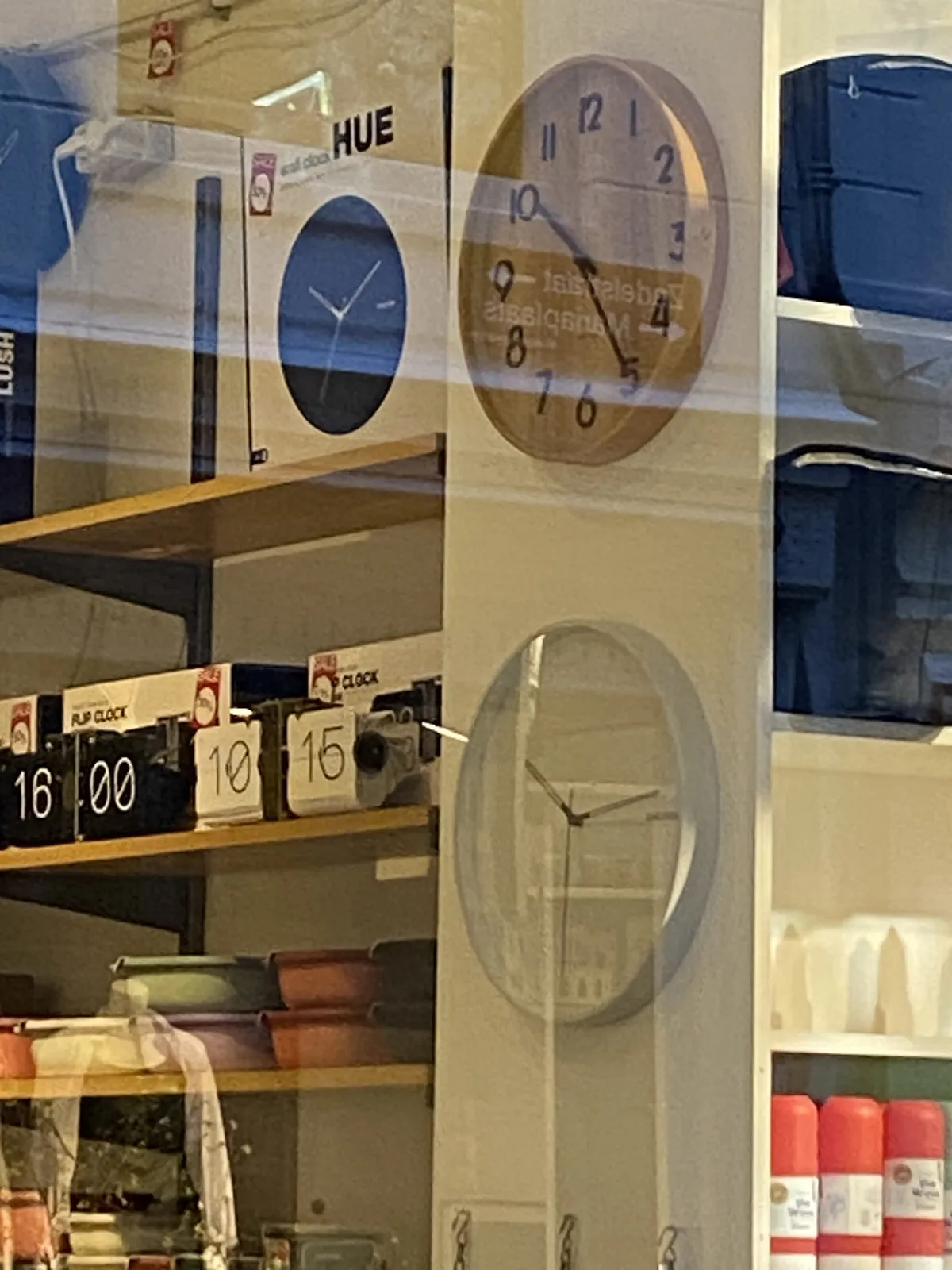 Different clocks for sale in this shop. Three of them have hands. One of these points at 11 past 10, another at 14 past 10, and the other at 25 past 10. Two of them are mechanical, with flipping digits. One of these says it is 10:15, the other says it is 16:00. 