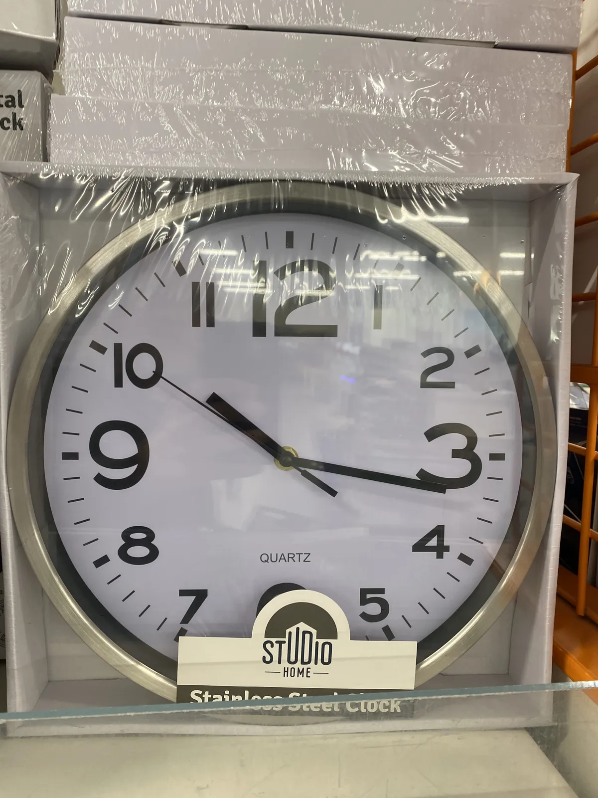 A clock in a box points at 17 past 10.