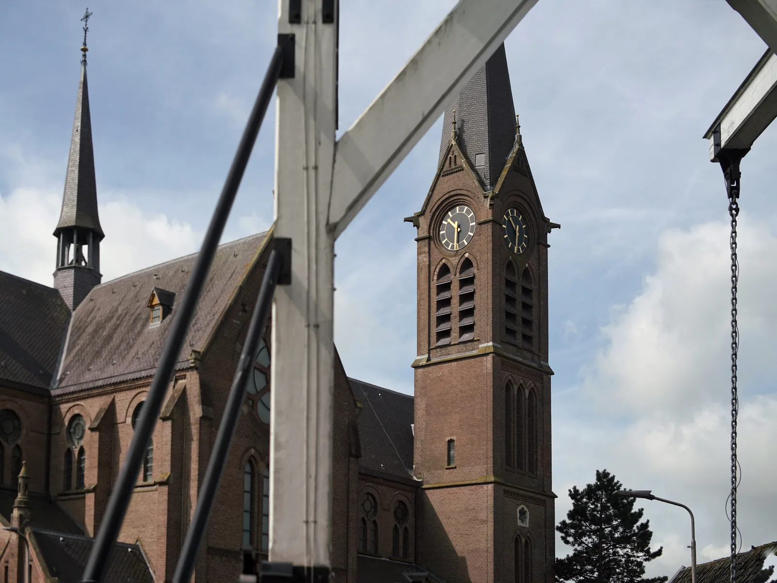 An old church with a tower. On the tower there’s a clock that points at 31 past 10.