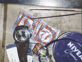 Two packs of condoms, some cream and a clock, which points at 31 past ten.