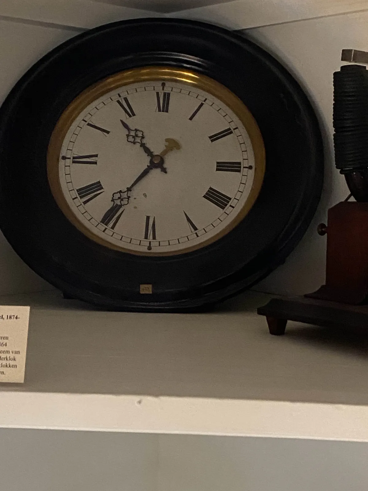 A clock with latin numbers that points at 24 to 11.