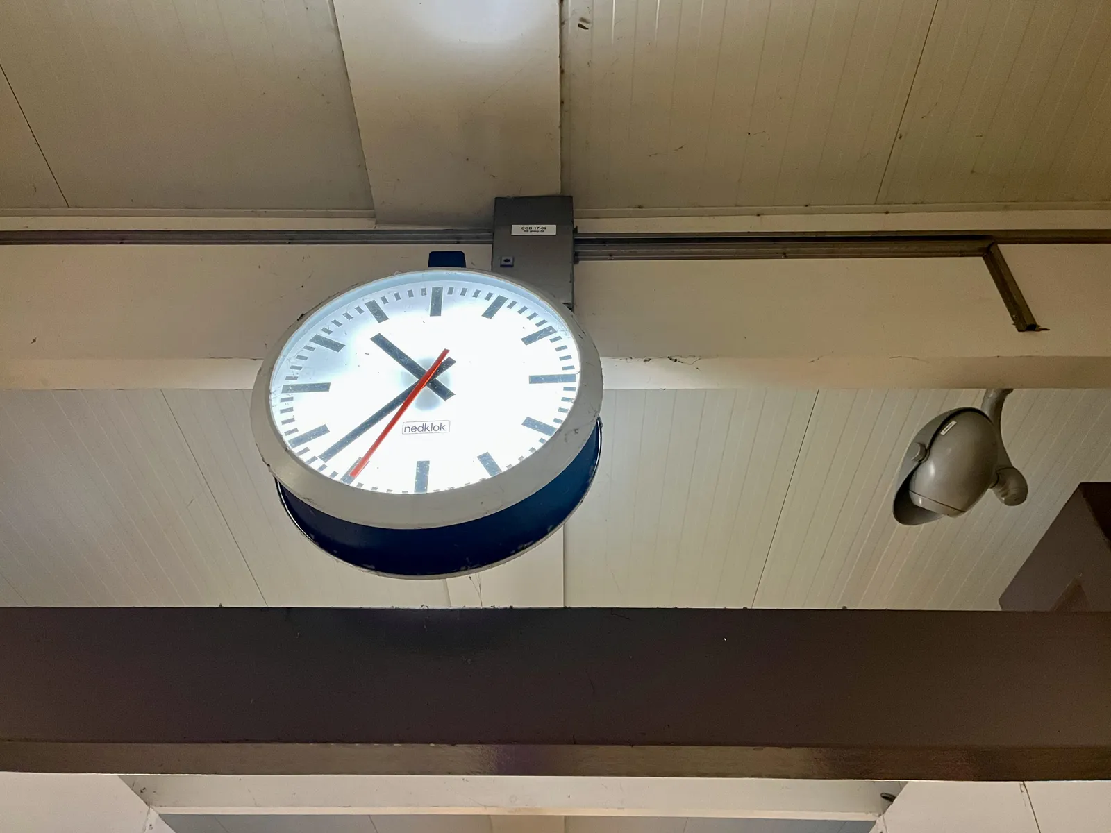 A clock somewhere on a station points at 37 past ten.