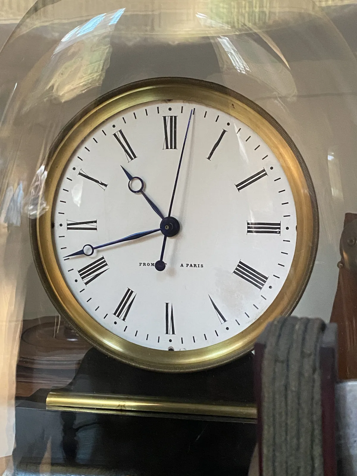 A clock in a glass dome points at 10:42.