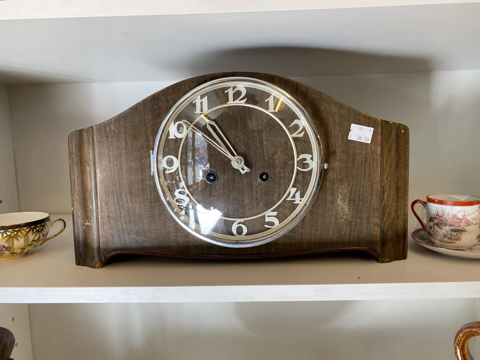 An old wooden clock. It points at 9 to 11.