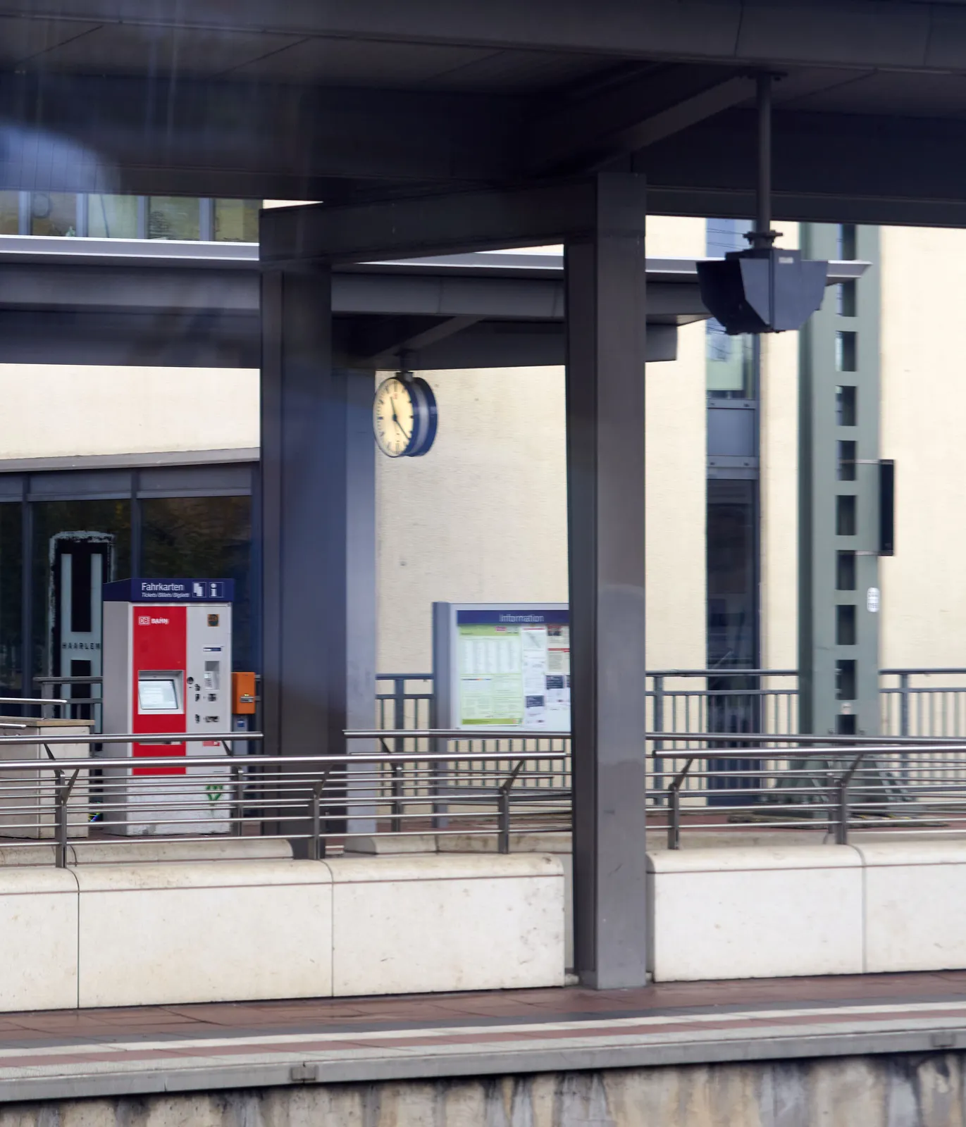 A clock on a train station. It points at 22 past 11.