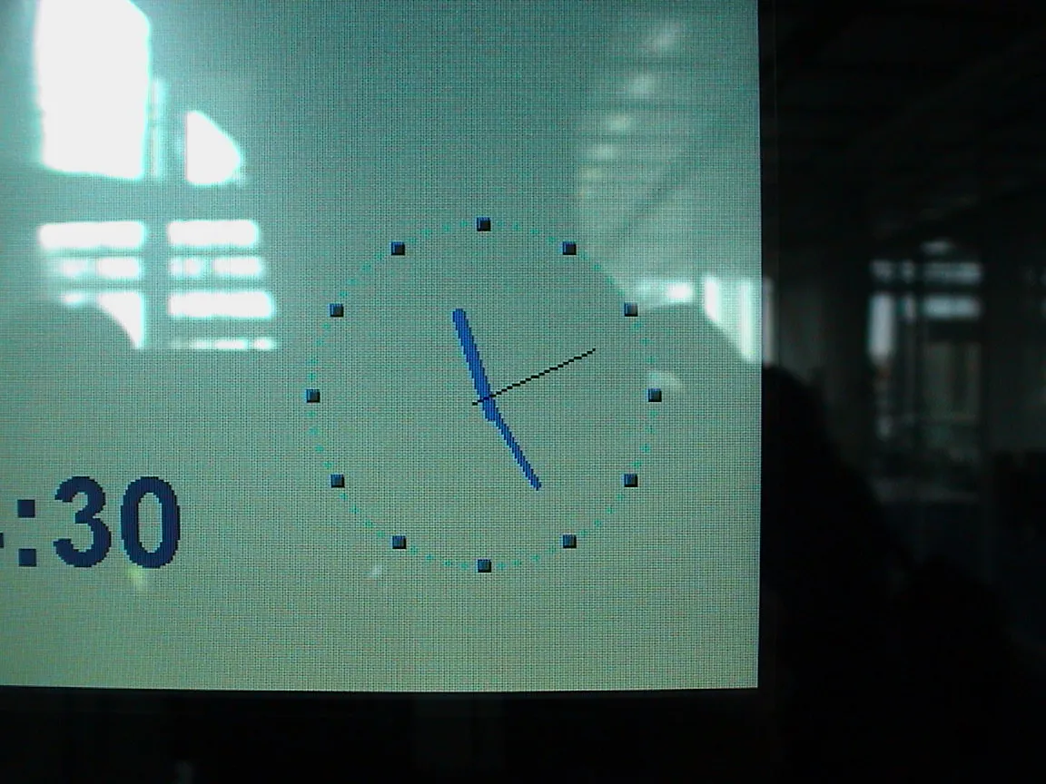 A rather pixelated digital clock probably points at 25 past 11.