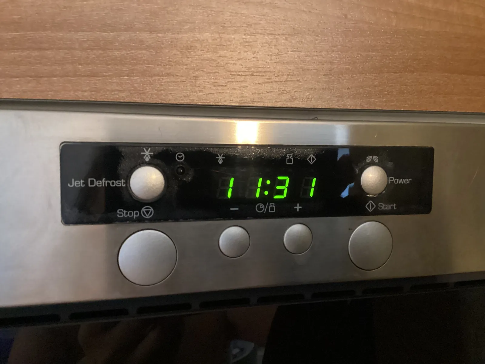 The clock on this microwave oven says it is 31 past eleven.