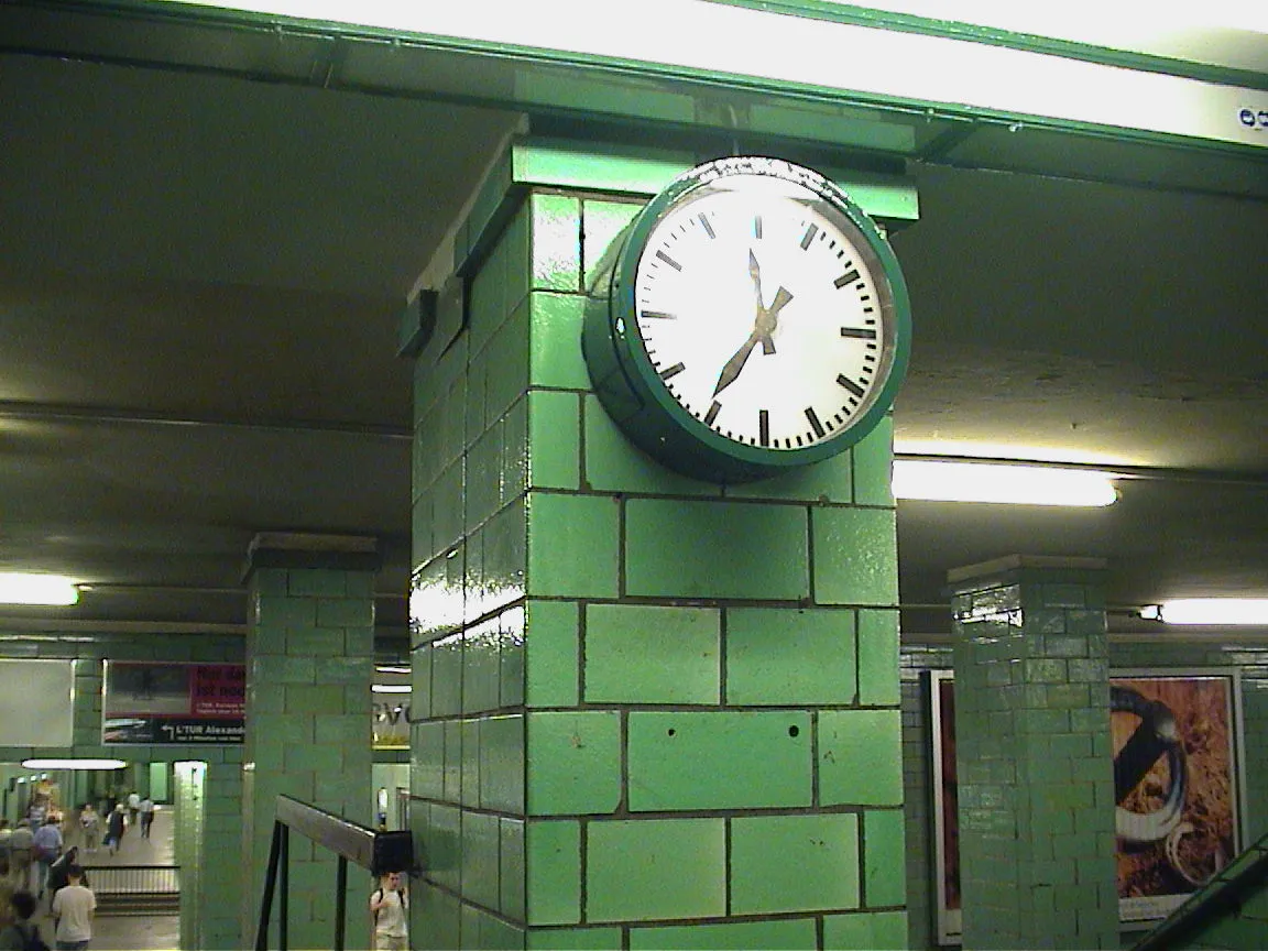 This large wall clock points at 36 past eleven.