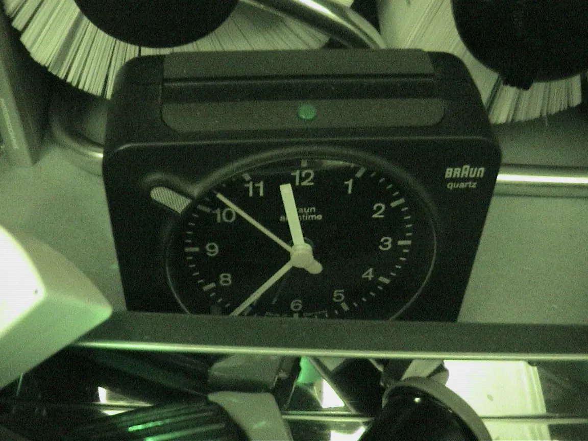 This Braun travel clock points at 36 past 11.