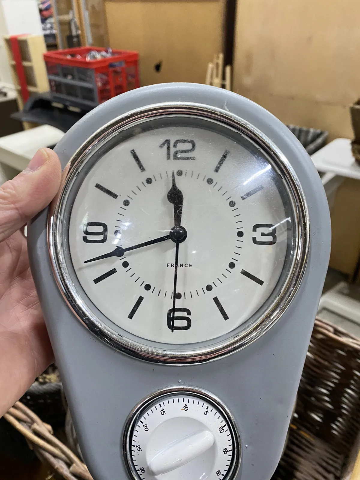 There’s a clock and a mechanical timer on this gray thing. The clock points at 18 minutes to 12.