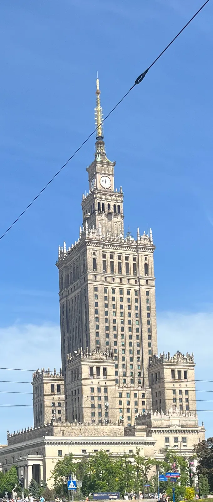 The enormous Palace of Culture and Science in Warsaw. There’s  a clock on top of it and it points at 13 minutes to 12.