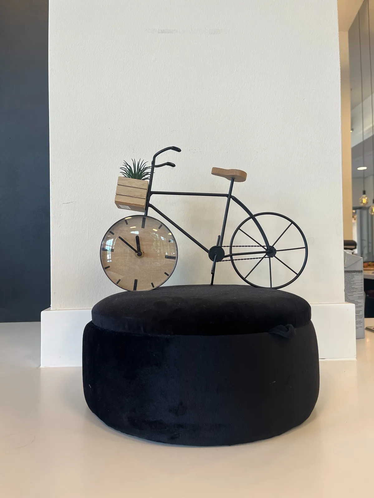 A little statue of a bycicle with a clock as a front wheel. It points at 10 to 12.
