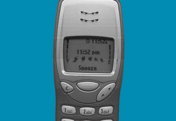 The time on the old Nokia phone is 11:52 PM