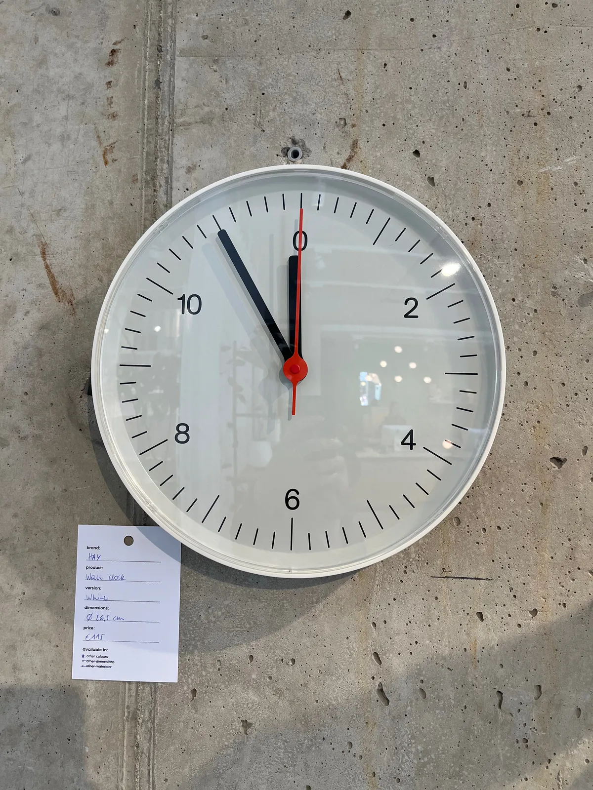 A modernist clock with the number 0 instead of the number 12 points at 5 minutes to 12. Or is it 5 minutes to zero?