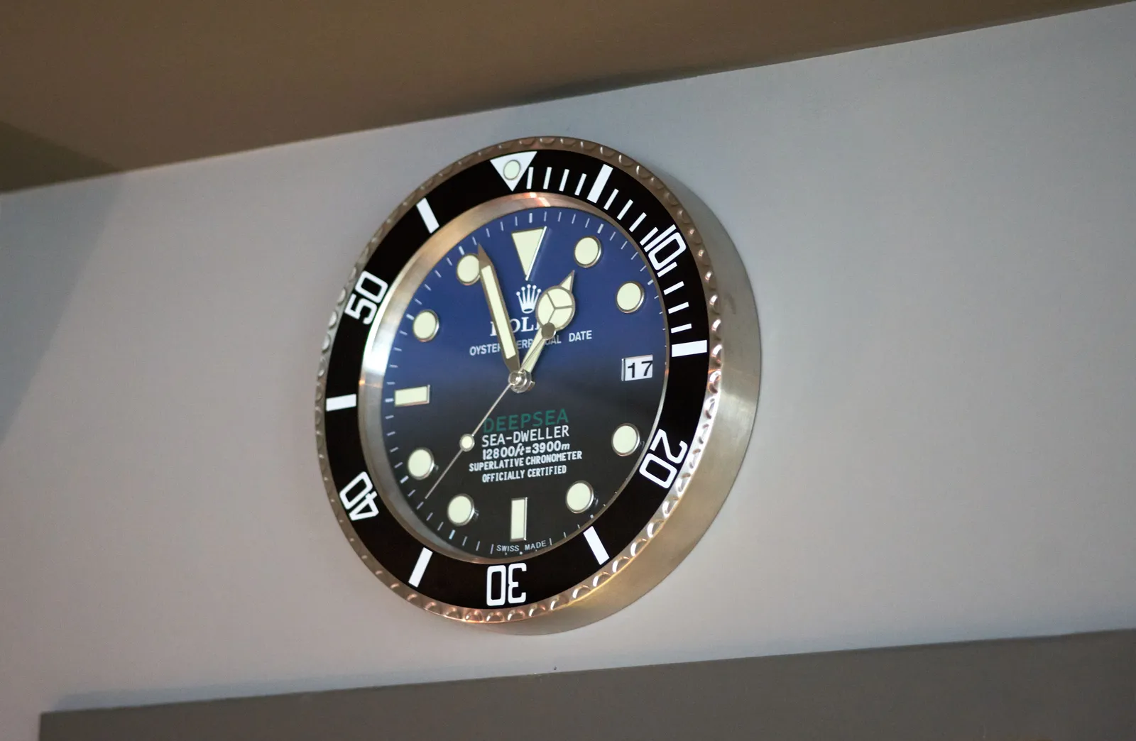 A posh rolex wall clock points at 4 minutes to 12.