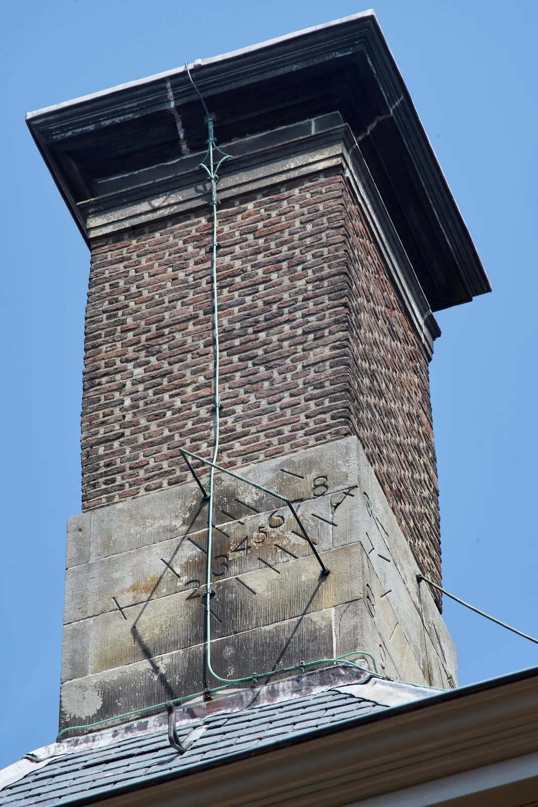 A west facing sundial attached to a chimney in Leiden. It points at five minutes past one, give or take a few minutes.