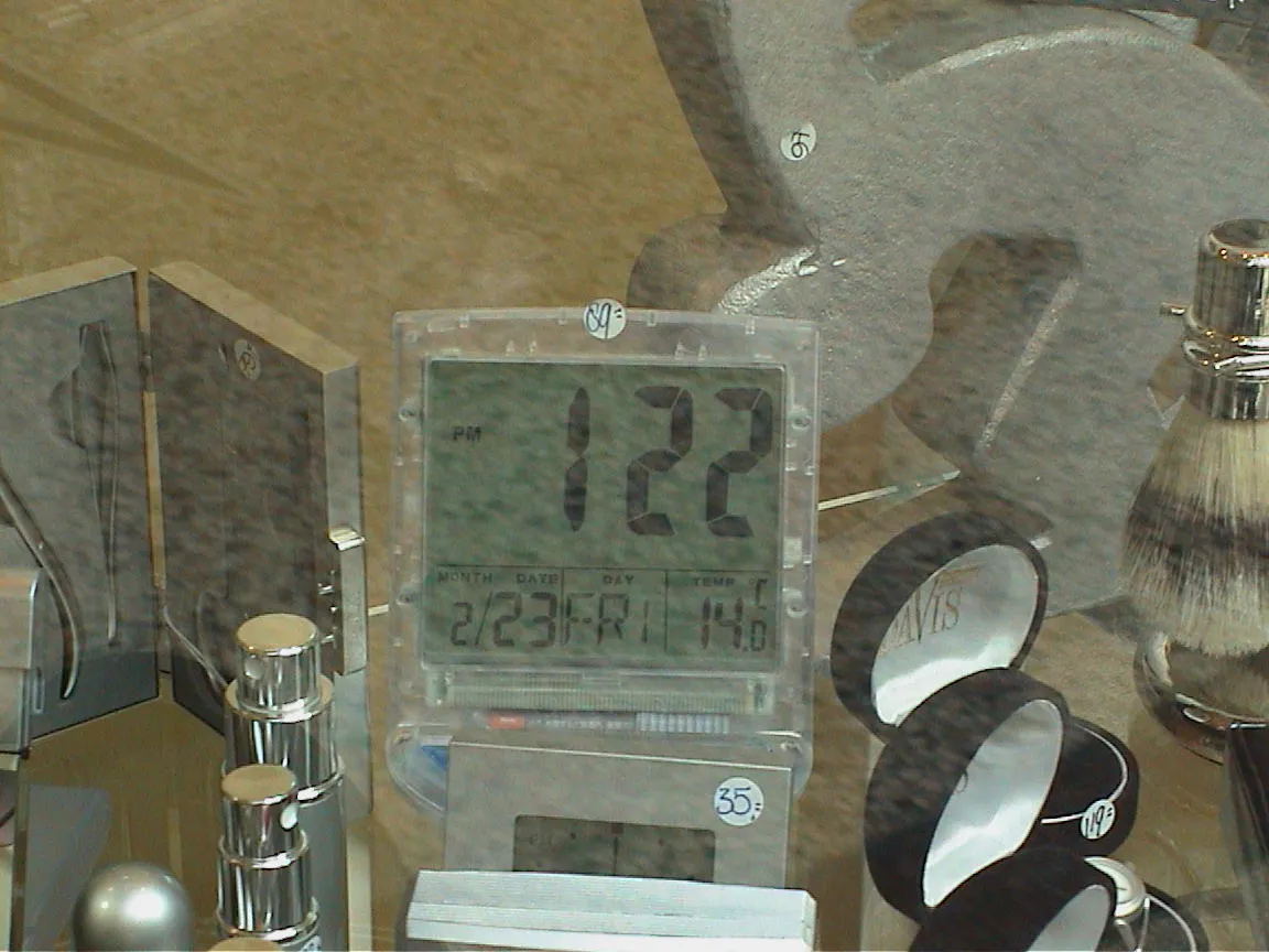 All kinds of cosmetics, and other luxurious products for sale. Among them a digital clock that says it is 1:22 pm