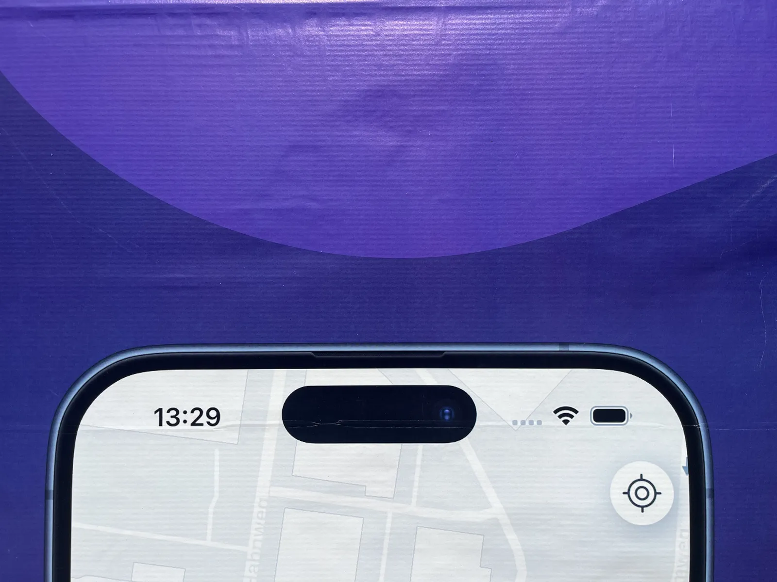 On this detail of a poster, with the top of a smart phone against a bright blue background. In the top left corner of this smart phone the time is shown as 13:29