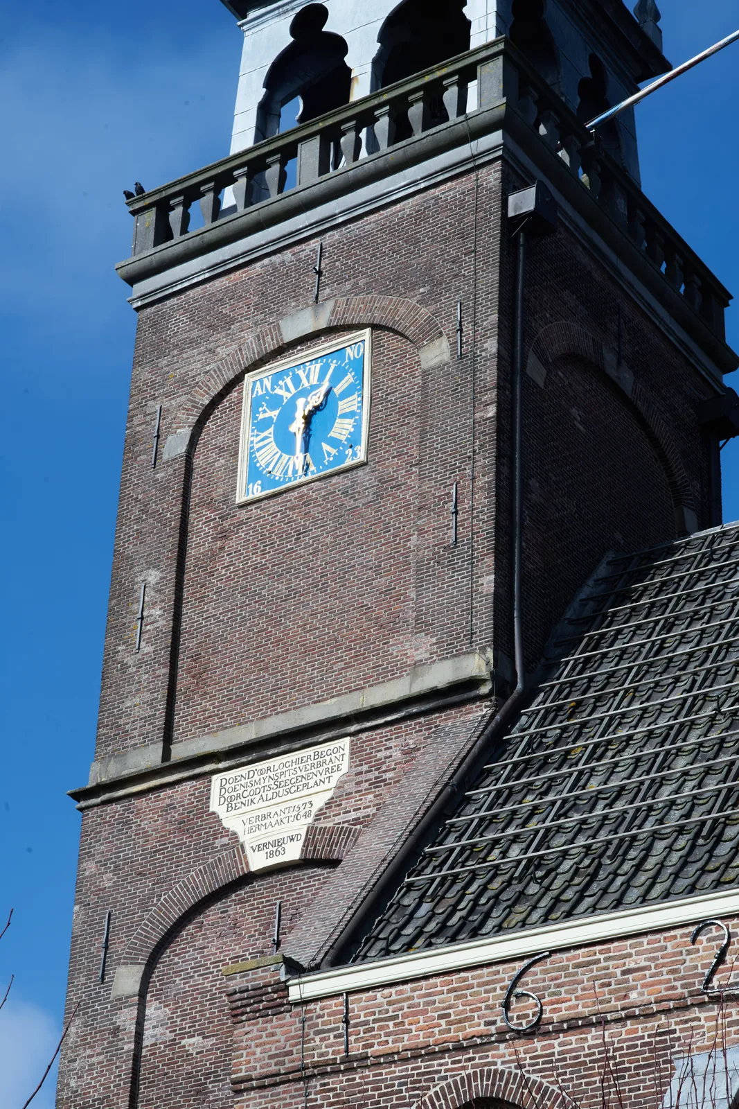 A clock on a church in Broek in Waterland points at half past one.