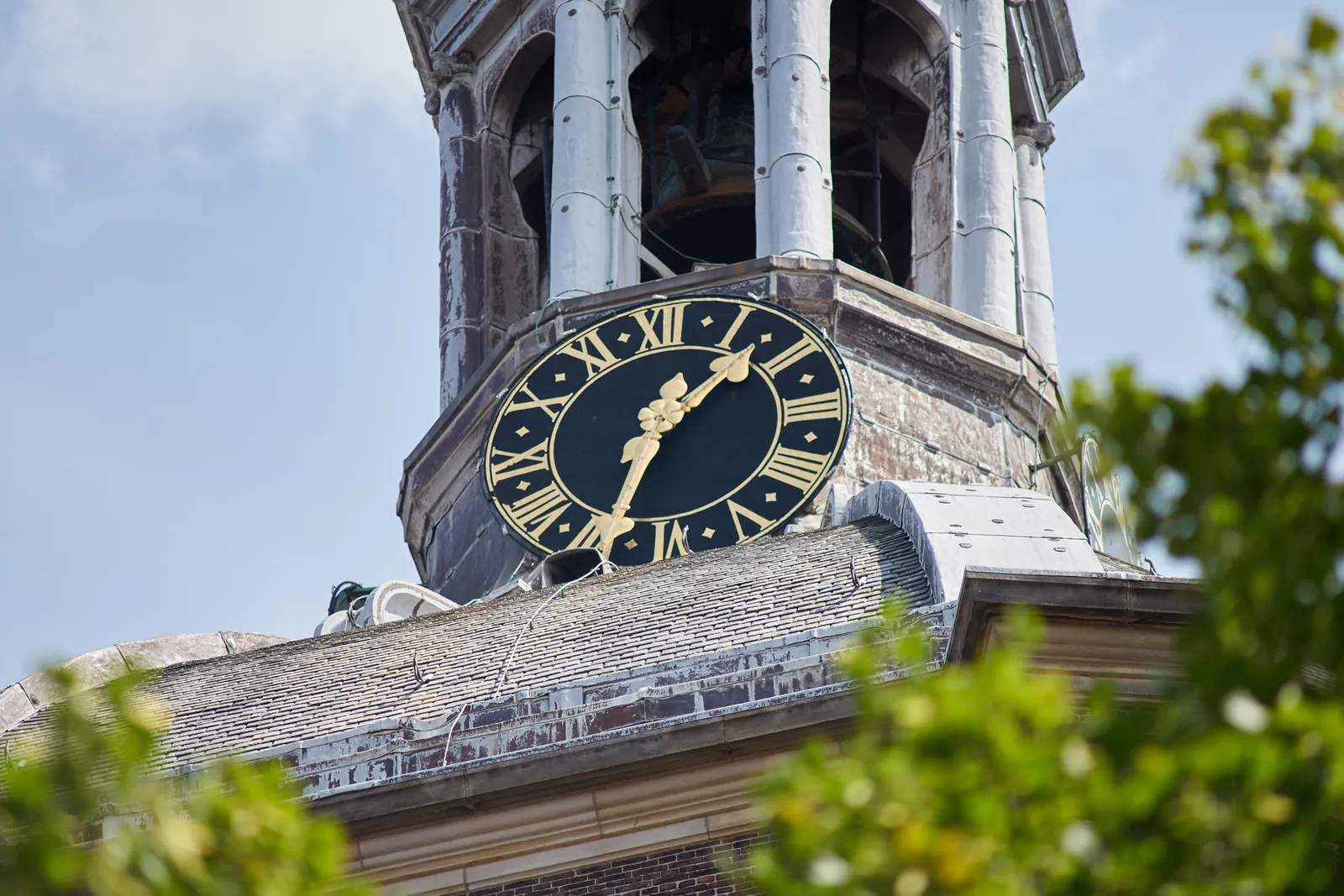 A clock on top of a church dome. It points at approximately 26 minutes to two.