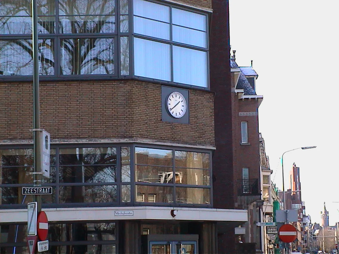 A modernist clock in the Zeestraat, probably somewhere in the Netherlands, says it’s 22 to two.