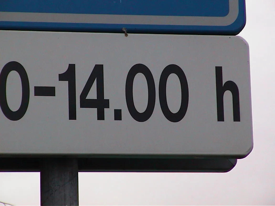 A street sign says 14:00 h.