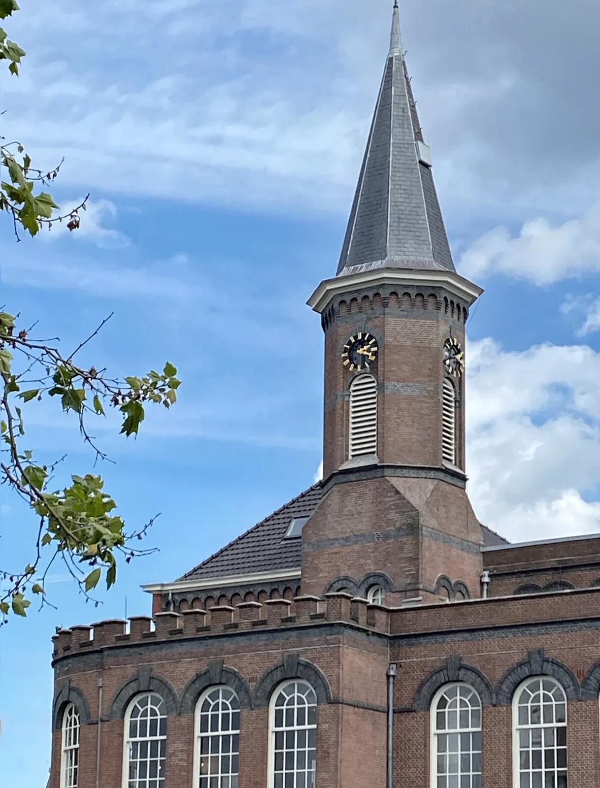 A rather strange, eclectic church with a clock on it. It points at 19 minutes past 2.