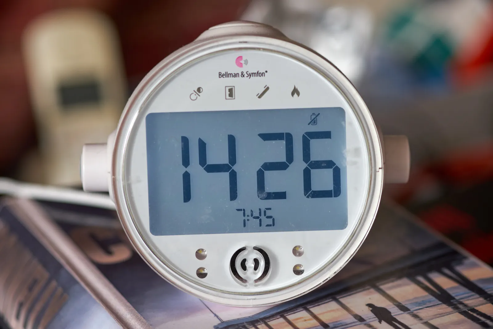 A round digital clock says in very large type that it is 14:26.