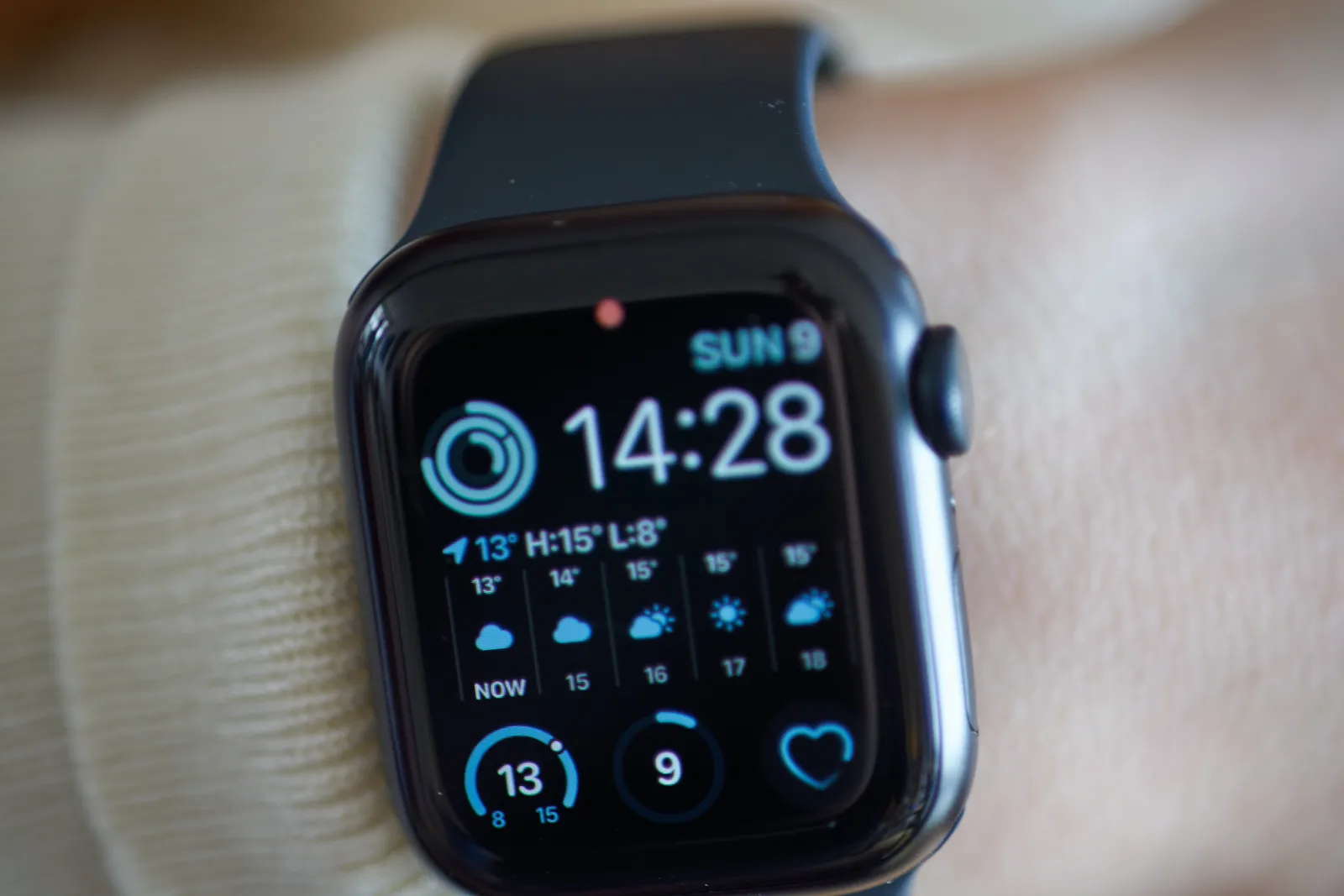 An Apple Watch. Quite some stuff on its display, among others the time. It is 14:28.