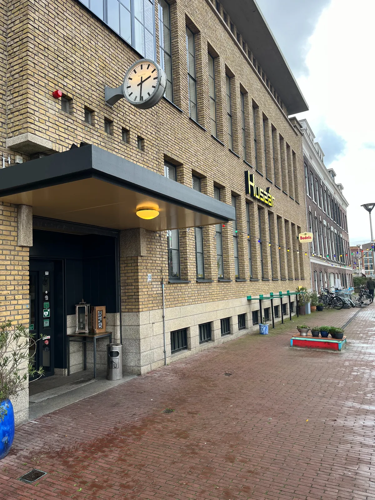 A clock attached to cafe Huszar in Delft. It points at 29 minutes to 3.
