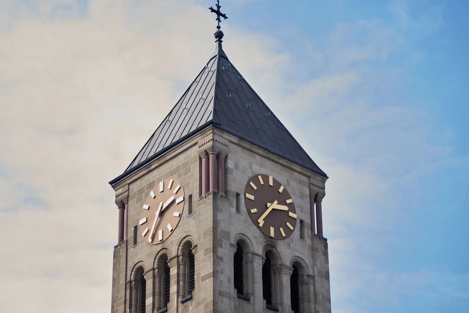 A church tower clock points at 36 past 2.
