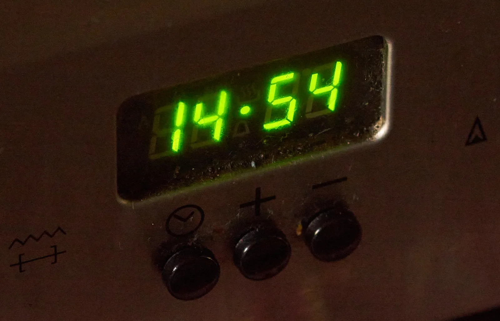 A digital clock on an oven shows the time. It is 14:54.