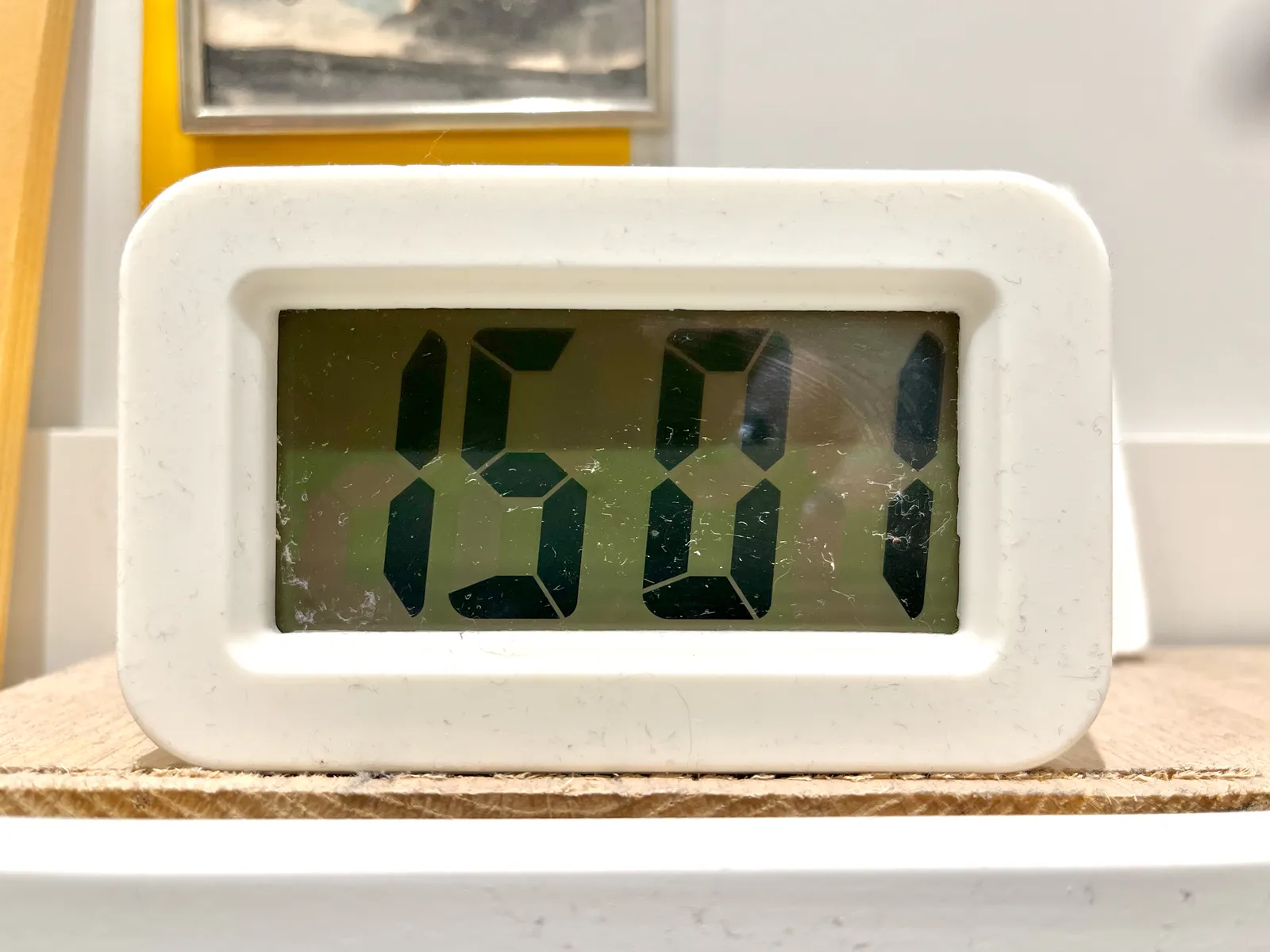 A digital clock fills the image. It displays the time as 15:01.