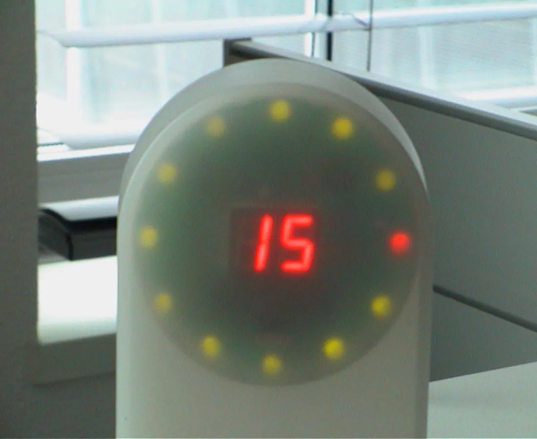 A novelty clock points at fifteen minutes after fifteen.