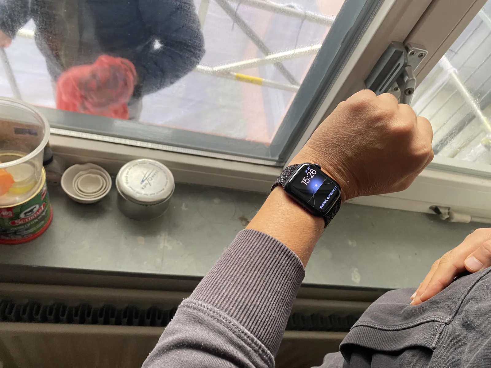 Someone is wearing a digital watch. It says it is 26 past 3.