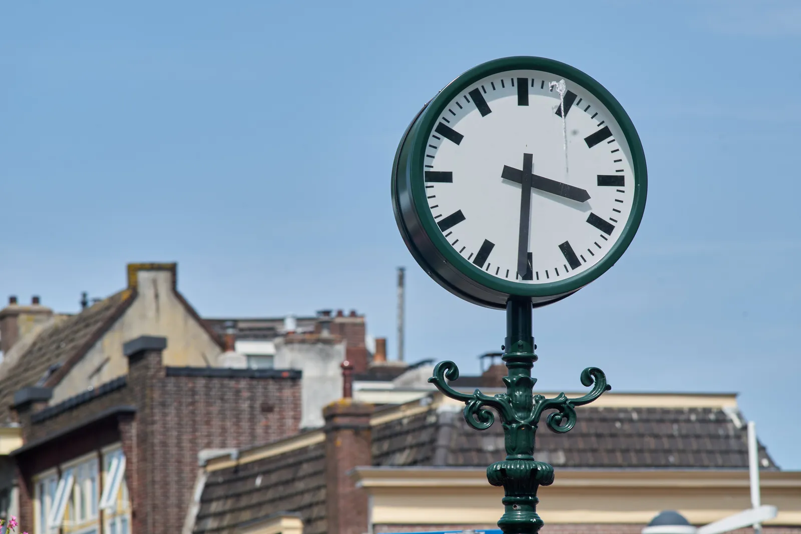 A bird pooped on this clock. The clock points at half past three.