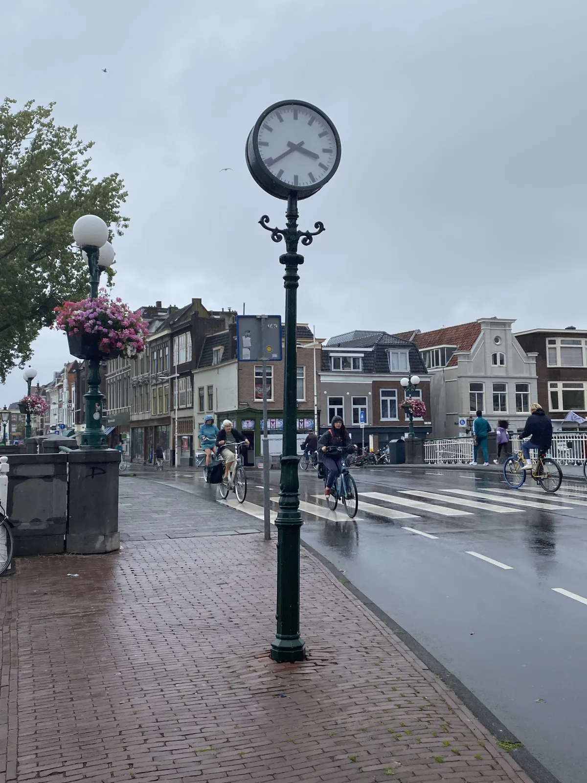 A clock in rainy Leiden. It points at 21 minutes to 4.