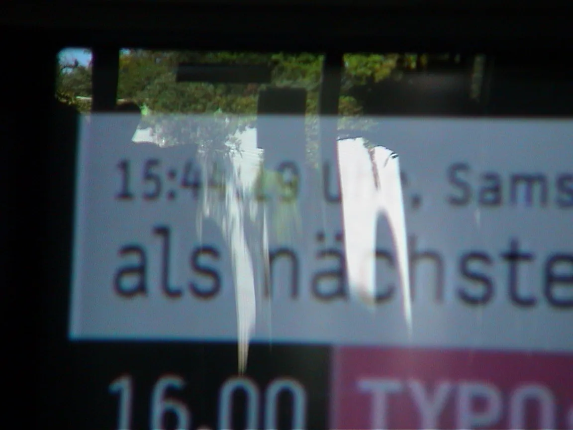 Behind some reflections on this glass you can read it is 15:44
