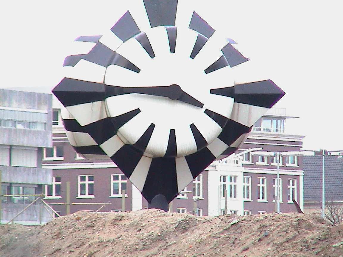 A very large zebra clock object points at a quarter to four.