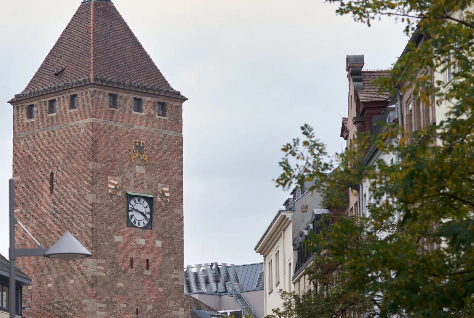 On the clock on this massive old tower it is 13 minutes to 4.