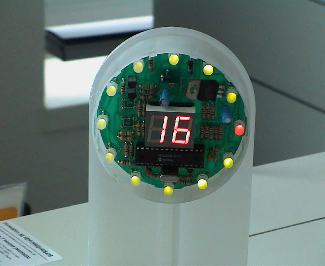 A clock where the computer hardware is clearly visible, says it is 16:15