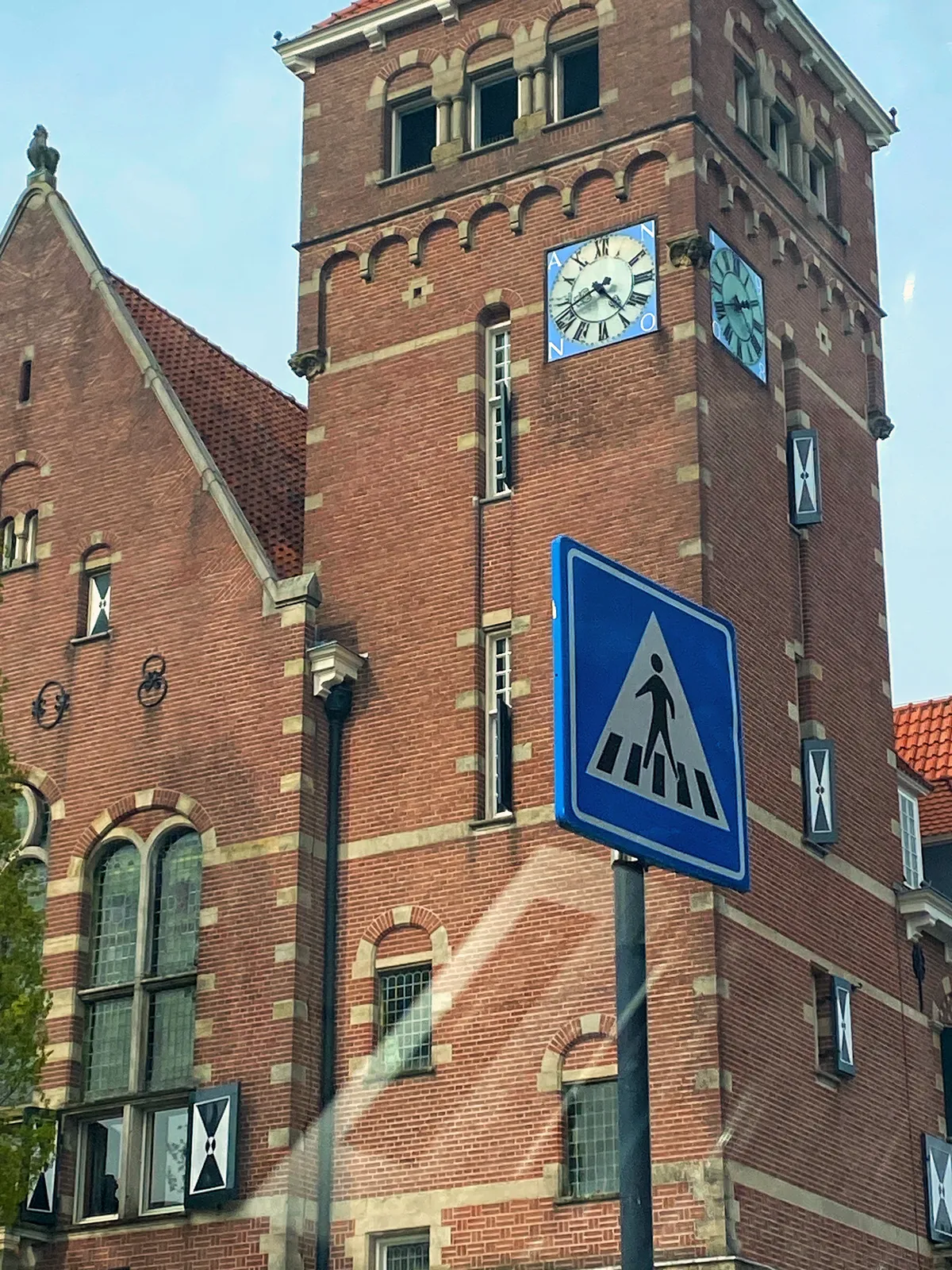 On an old tower there are two clocks. They both point at 18 minutes to five.