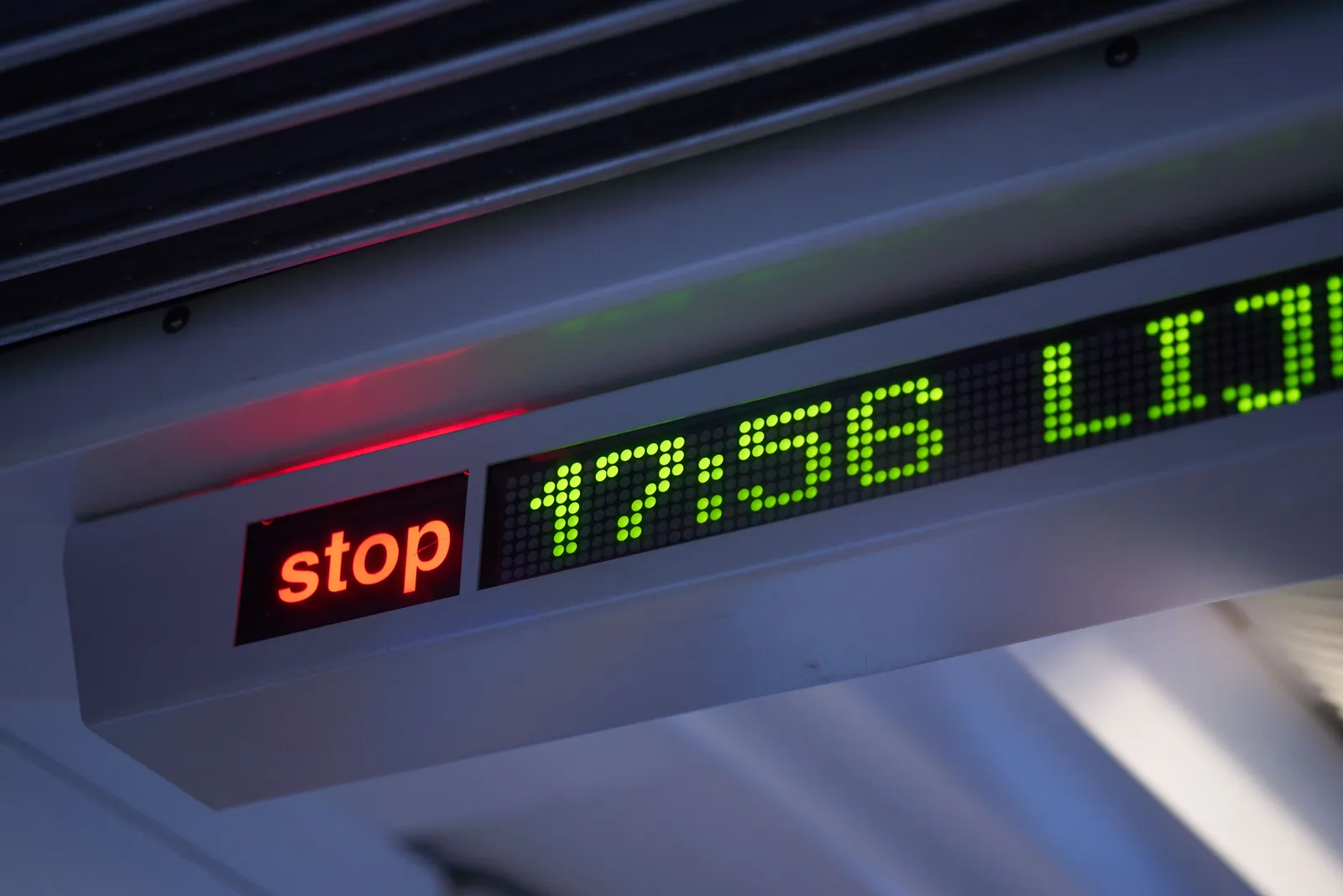 The red stop sign is lit, which means that the tram should halt at the next stop. On the bright green dotted display next to it the time says 17:56.
