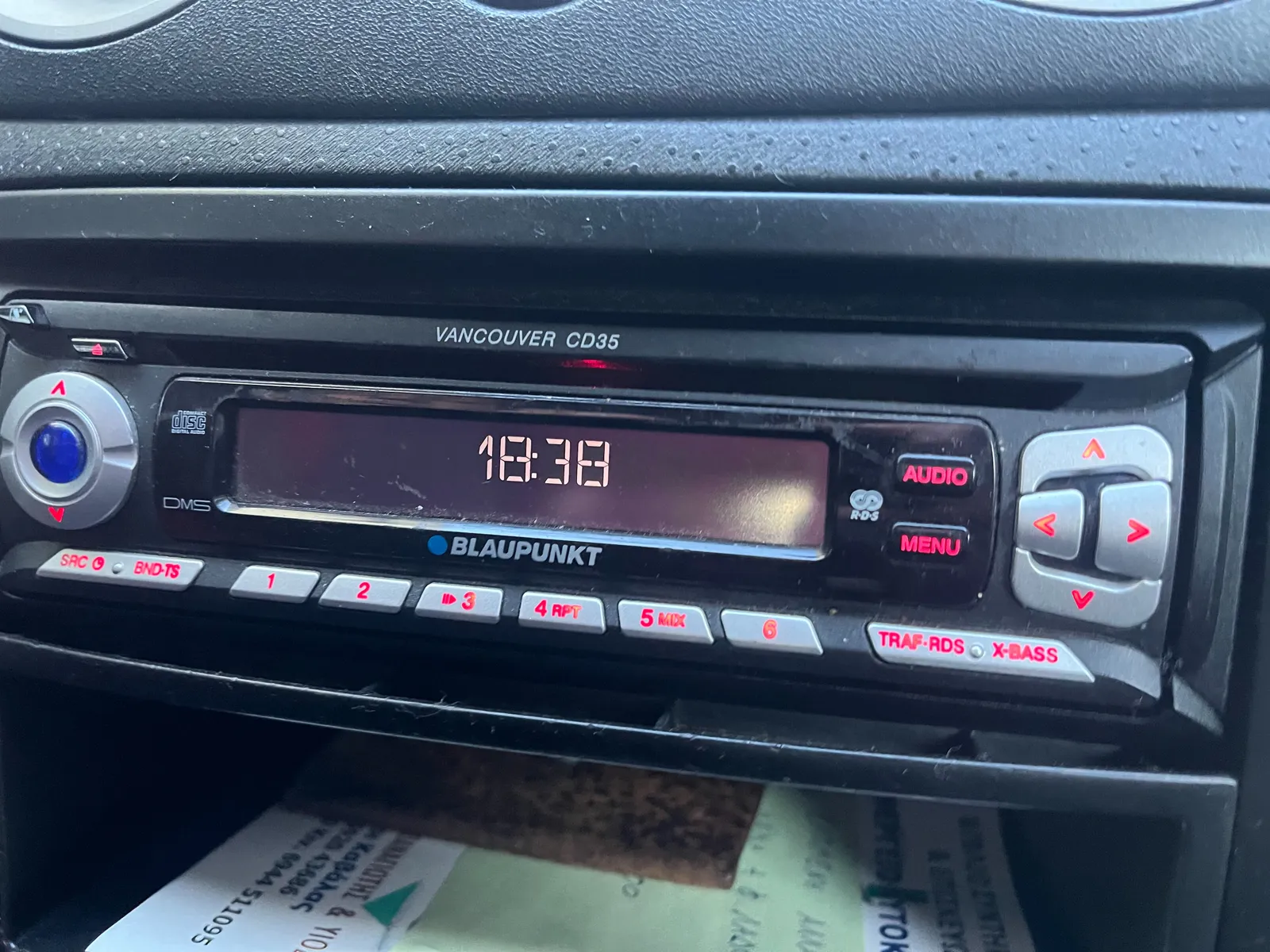 A car radio with the time on its display. It says it is 18:38