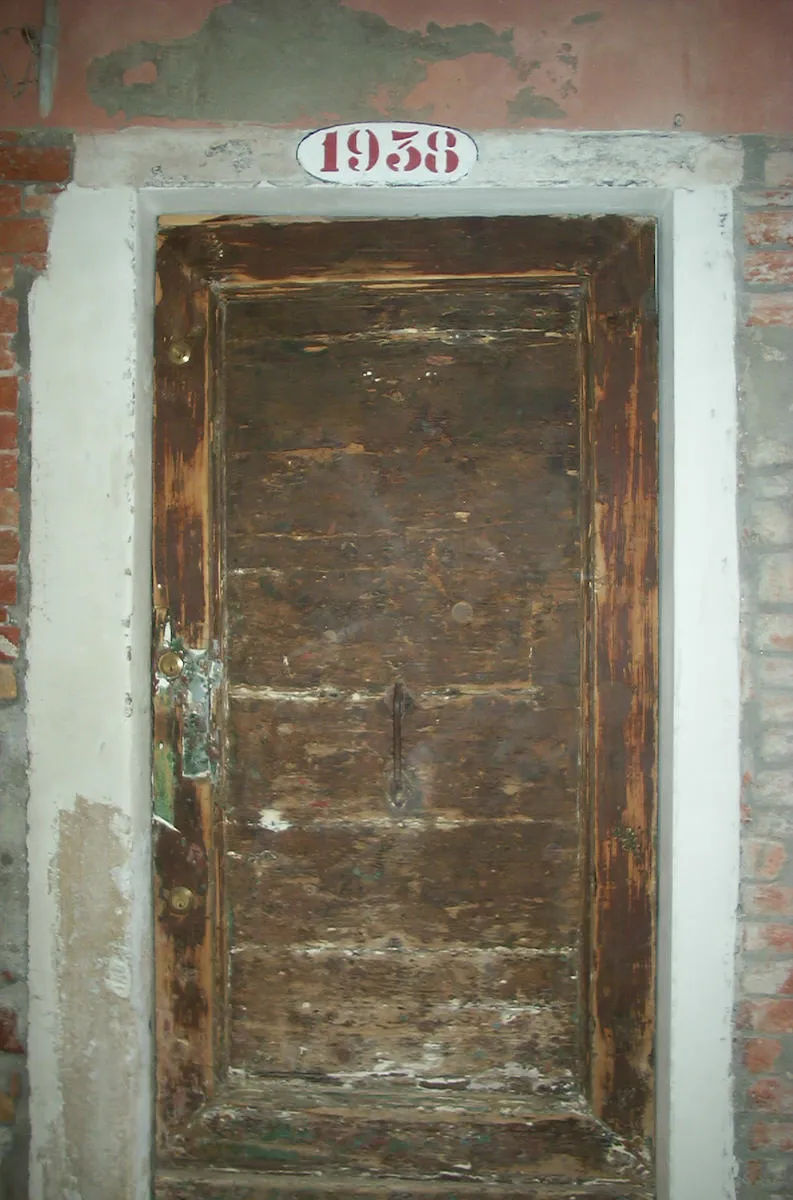 The house number above this old wooden door in Venice is 1938