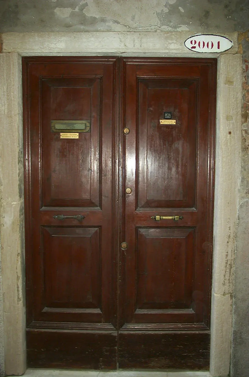 The house number above this old but shiny wooden door in Venice is 1938