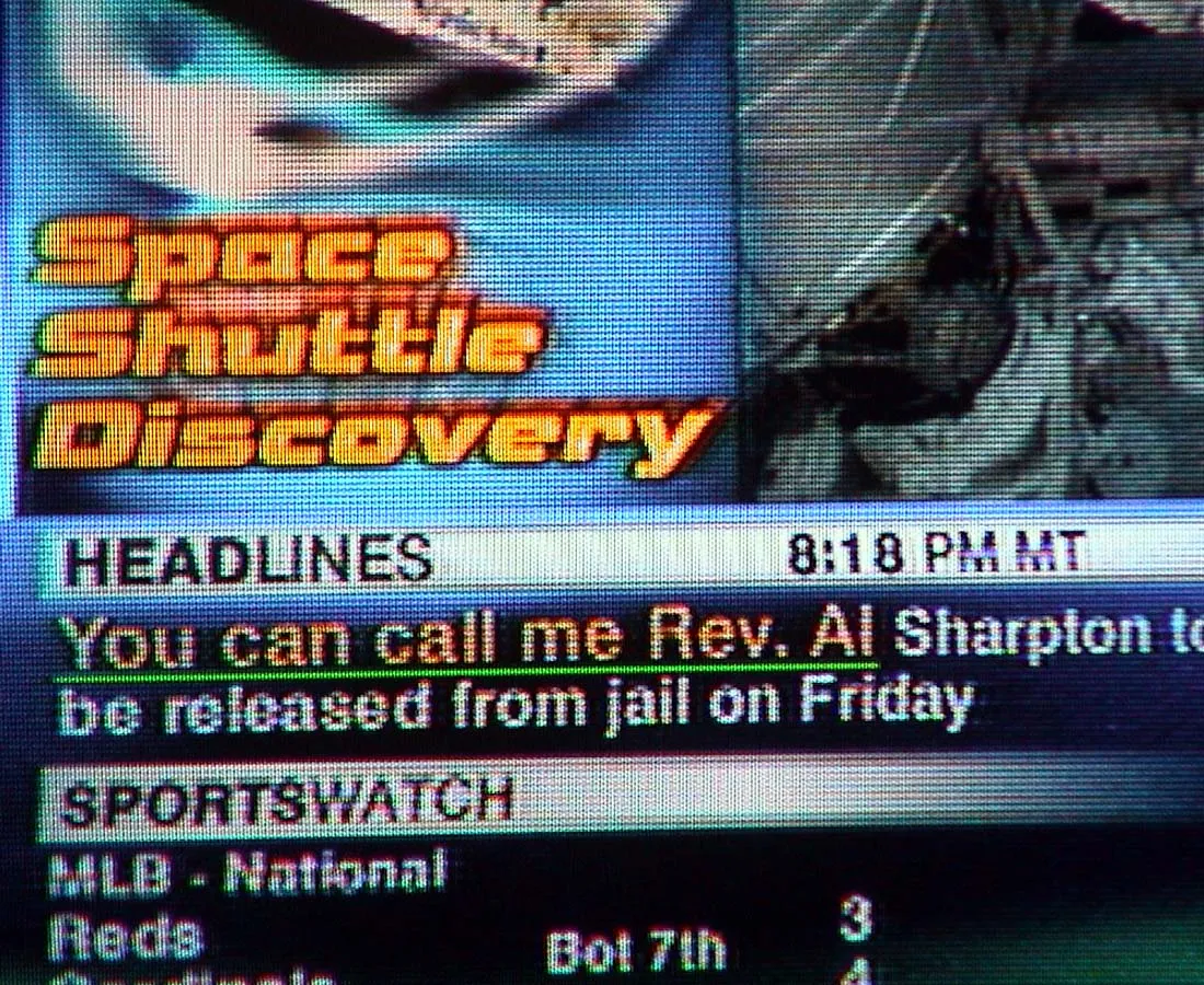 All kinds of information on this photo from a TV screen. Among those things is the time, which is 8:18 PM.