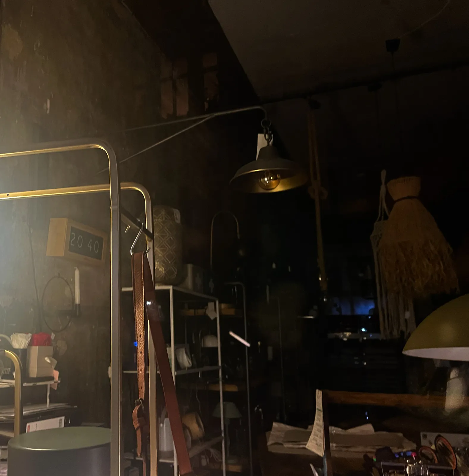 All kinds of stuff for sale in this shop. On the wall there’s a digital clock that reads 20:40.
