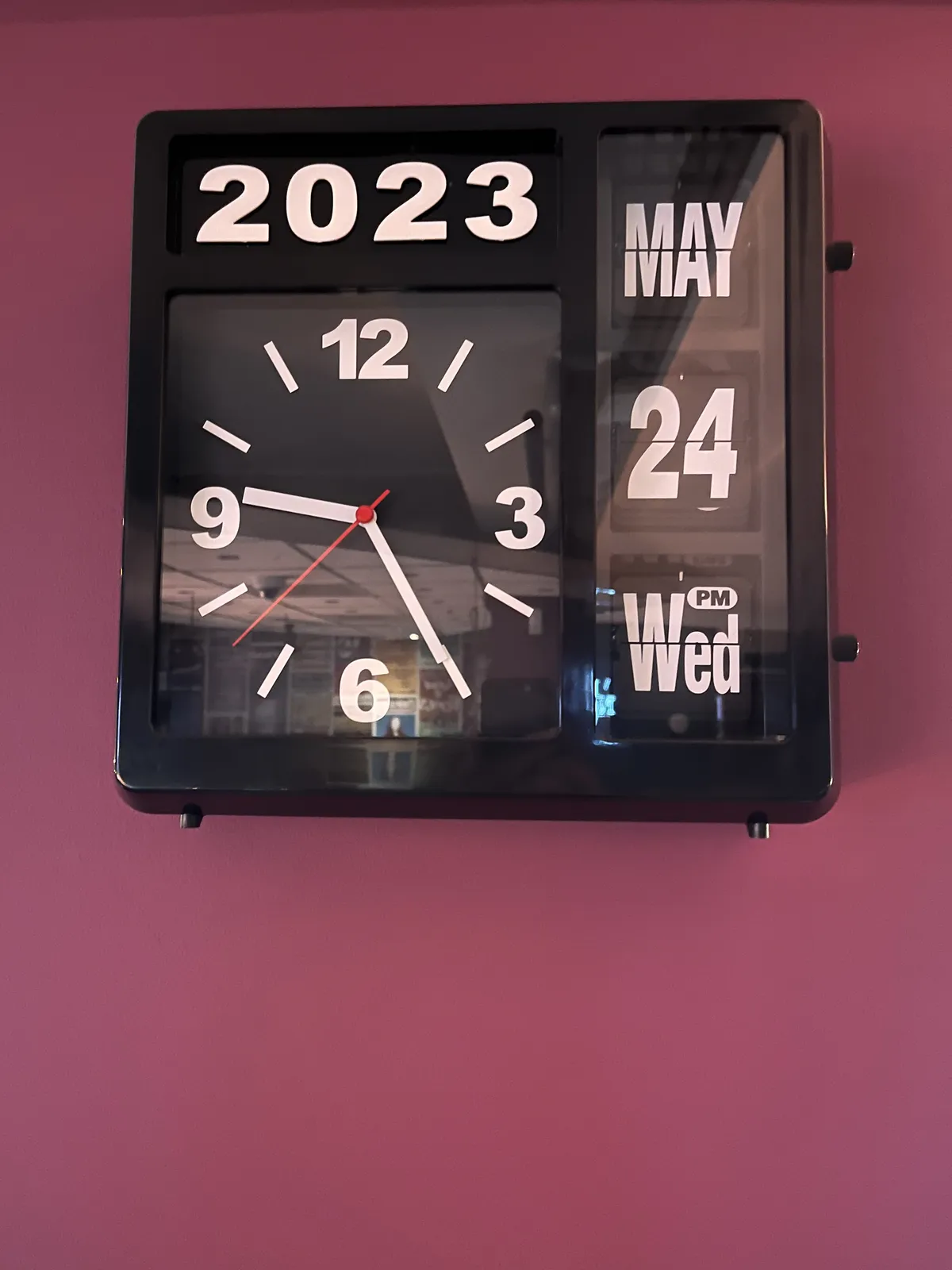A date and time clock. It is debatable if the chosen hierarchy is the most efficient, but is does look complete. The picture was taken in 2023 in May, on the 24th, which, it says, was a Wednesday. There’s also a very small sign that says PM. On the clock it’s 25 past nine.