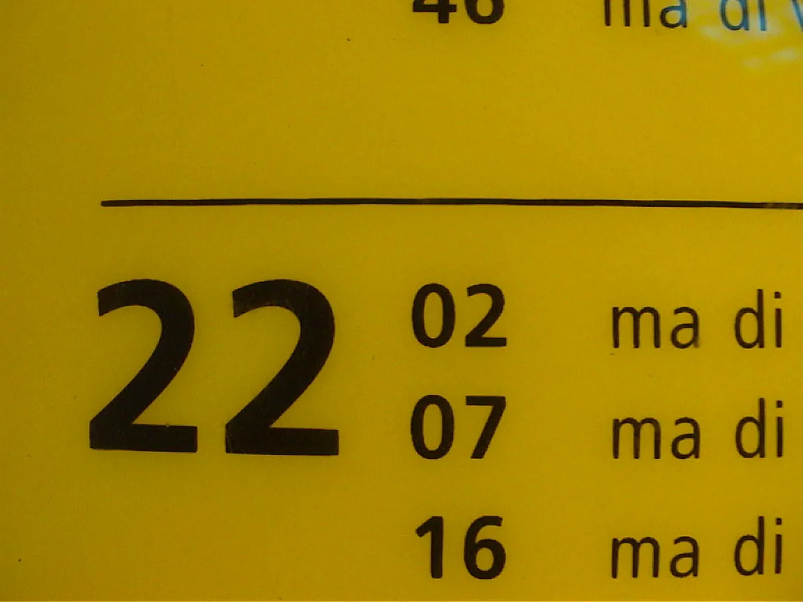 22:02 is printed on this yellow train schedule.